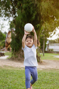 Full length of cute baby boy on field