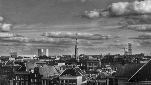 Cityscape against cloudy sky