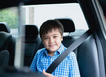 Portrait of boy sitting in car