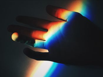 Close-up of hand on illuminated light