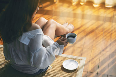 High angle view of woman holding coffee cup