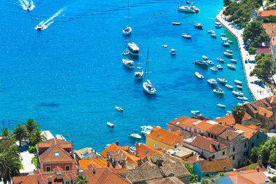 High angle view of cityscape by sea against sky