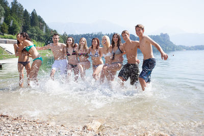 Portrait of friends playing in lake