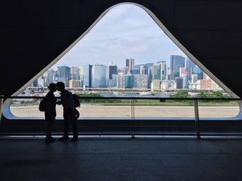 Full length of man and woman standing in city