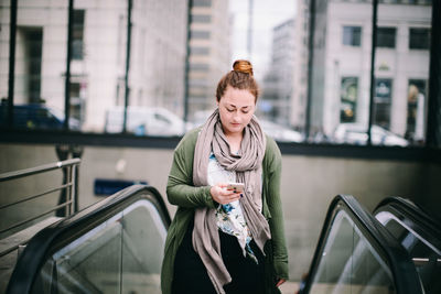 Full length of woman standing against bus