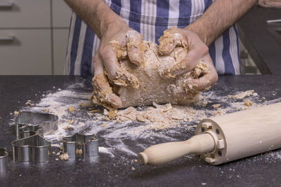 Male hands making dough for cookies