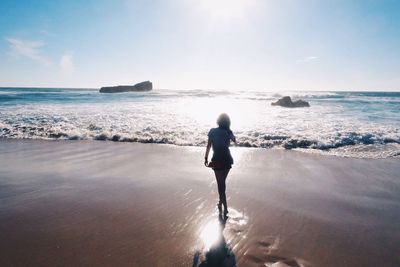 Rear view of woman on beach