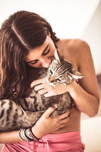 Midsection of woman holding kitten