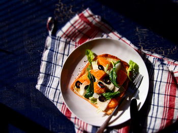 High angle view of salad on toasted bread in plate