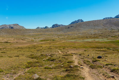 Scenic view of mountains against clear blue sky