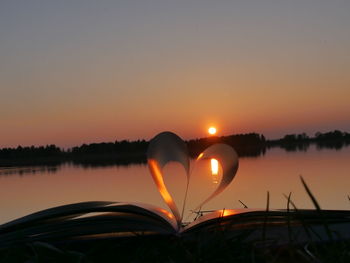 Scenic view of lake against orange sky