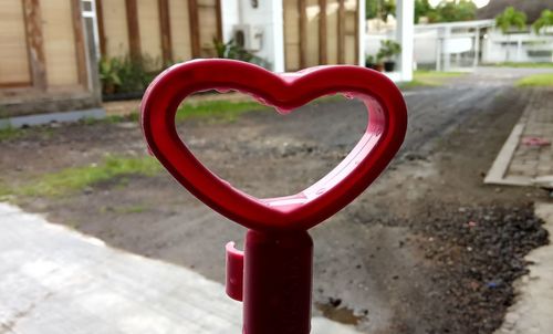 Close-up of red heart shape on street