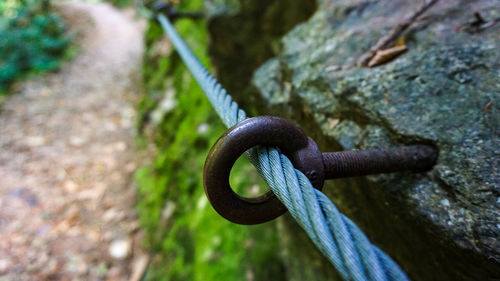 Close-up of rusty chain on rock