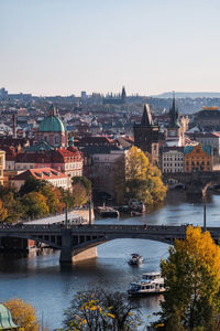 Bridge over vltava river against buildings in prague 