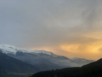 Scenic view of snowcapped mountains against sky during sunset