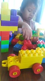 Boy playing with toy toys on table