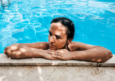 Young woman in bikini in swimming pool. summer, lifestyle.