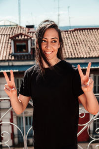 Young woman looking at camera with positive attitude on a rooftop.