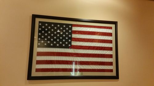 Low angle view of flag against wall