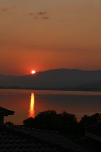 Scenic view of lake against romantic sky at sunset