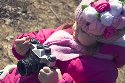 Close-up of girl holding camera