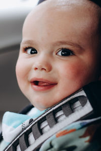 Sweet little baby boy in the car in baby safety seat