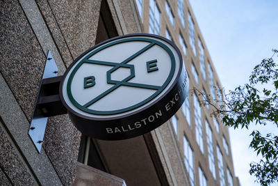 Low angle view of road sign against buildings