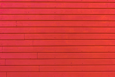 Wooden plank wall painted red
