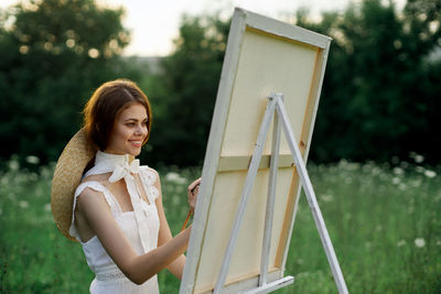 Portrait of young woman using digital tablet