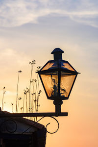 Low angle view of street light against sky during sunset