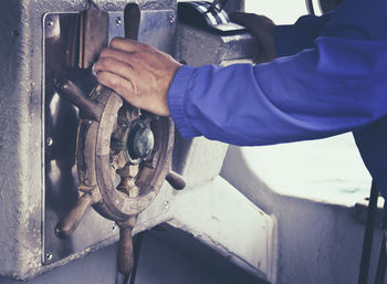 Close-up of hands on steering wheel