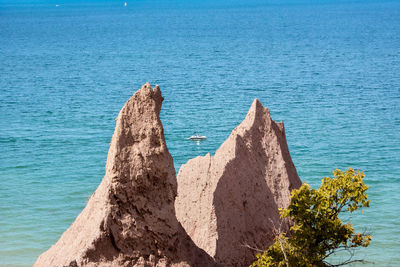 Glimpse of boat between cliffs