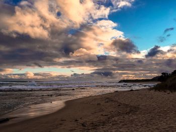 Scenic view of beach against sky during sunset