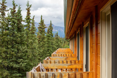 House amidst trees and buildings against sky