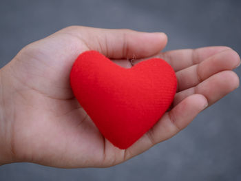 Close-up of hand holding heart shape