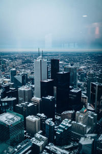 High angle view of cityscape by sea against sky