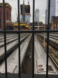 Railroad tracks in city against sky