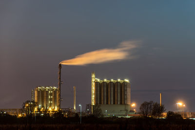 Smoke emitting from factory against sky at night