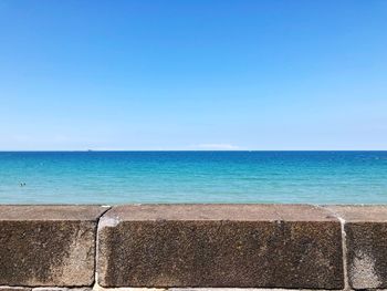 Scenic view of sea against clear blue sky