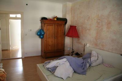 View of messy bed in bedroom