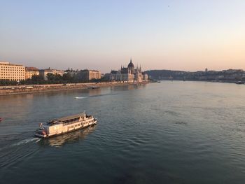 Boat in river with city in background