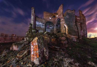 Low angle view of abandoned temple against sky