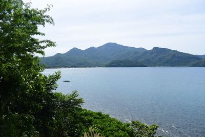 Scenic view of lake and mountains against sky