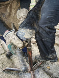 Low section of man working on metal