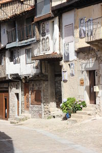 Old building by street in town