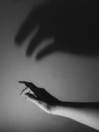 Cropped image of hand against black background