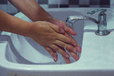 Midsection of woman in bathroom at home