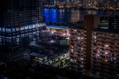 High angle view of illuminated buildings in city at night