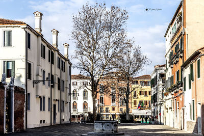 Street amidst buildings against sky in city
