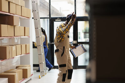 Rear view of woman holding book